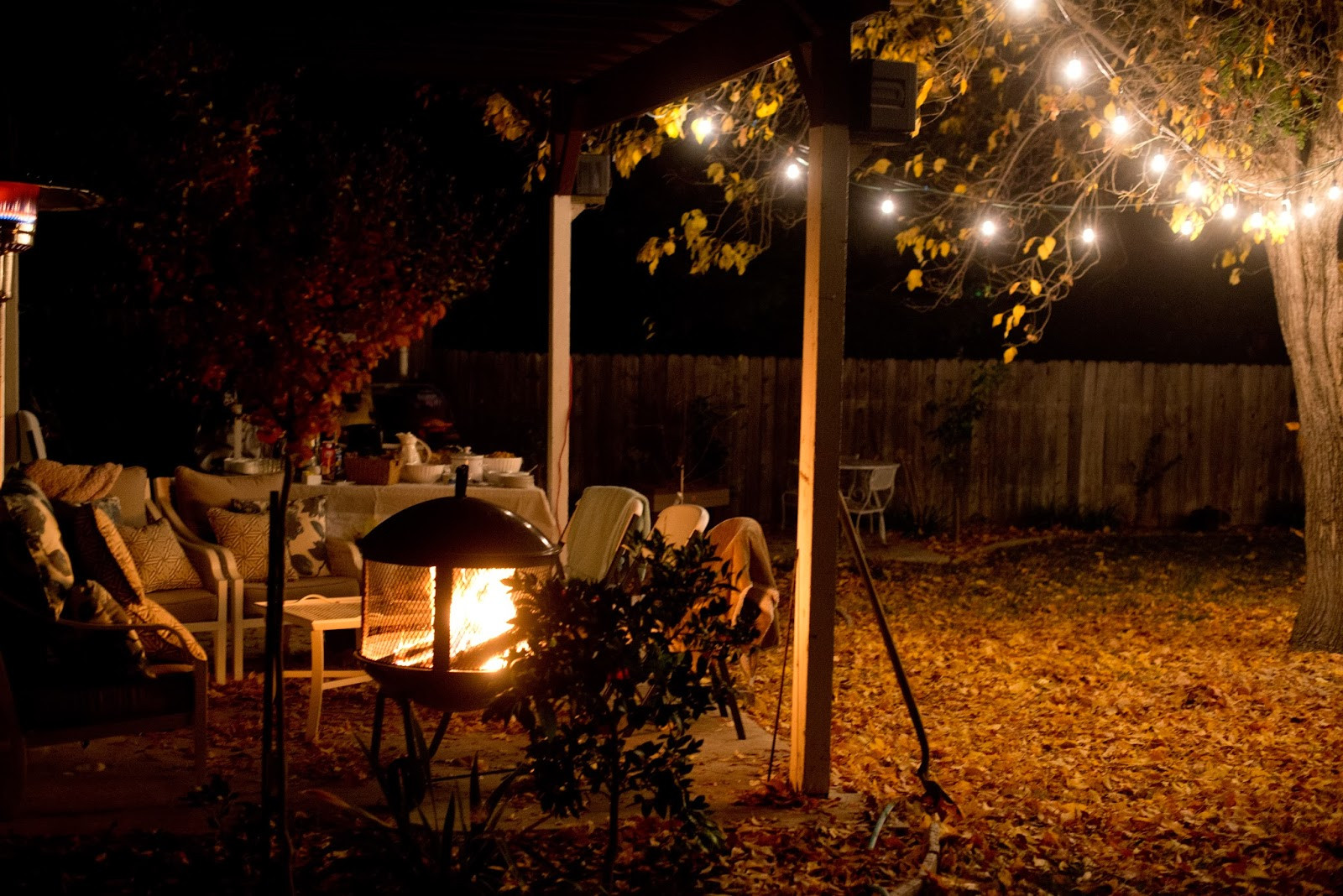 Backyard At Night
 Domestic Fashionista Backyard Fire Pit and Game Night