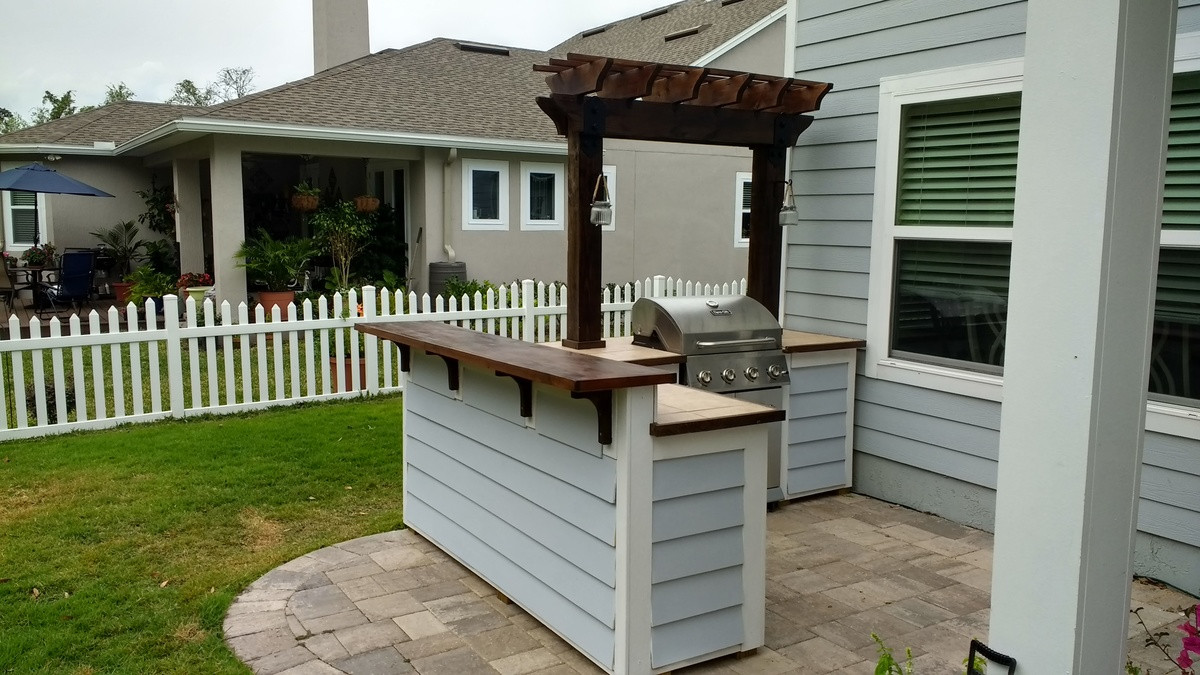 Backyard Grill &amp; Bar
 Outdoor bar grill surround with 2 post pergola