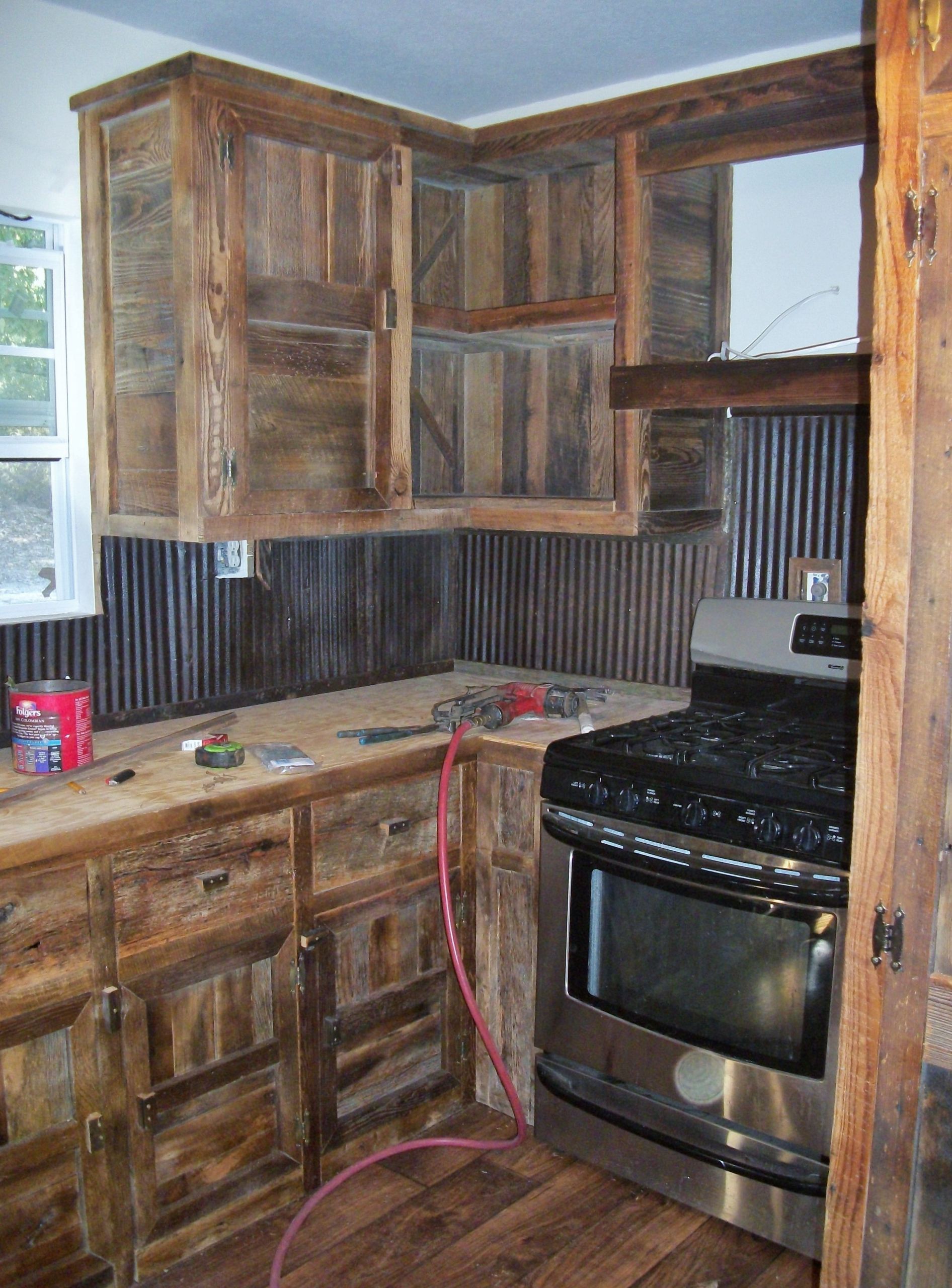 Barn Wood Kitchen Cabinets
 We built these barn wood cabinets and used old tin for a