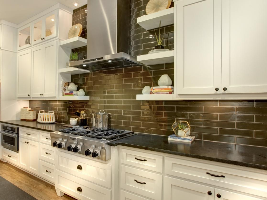 Dark Kitchen Backsplash
 White kitchen cabinets with dark subway tile backsplash