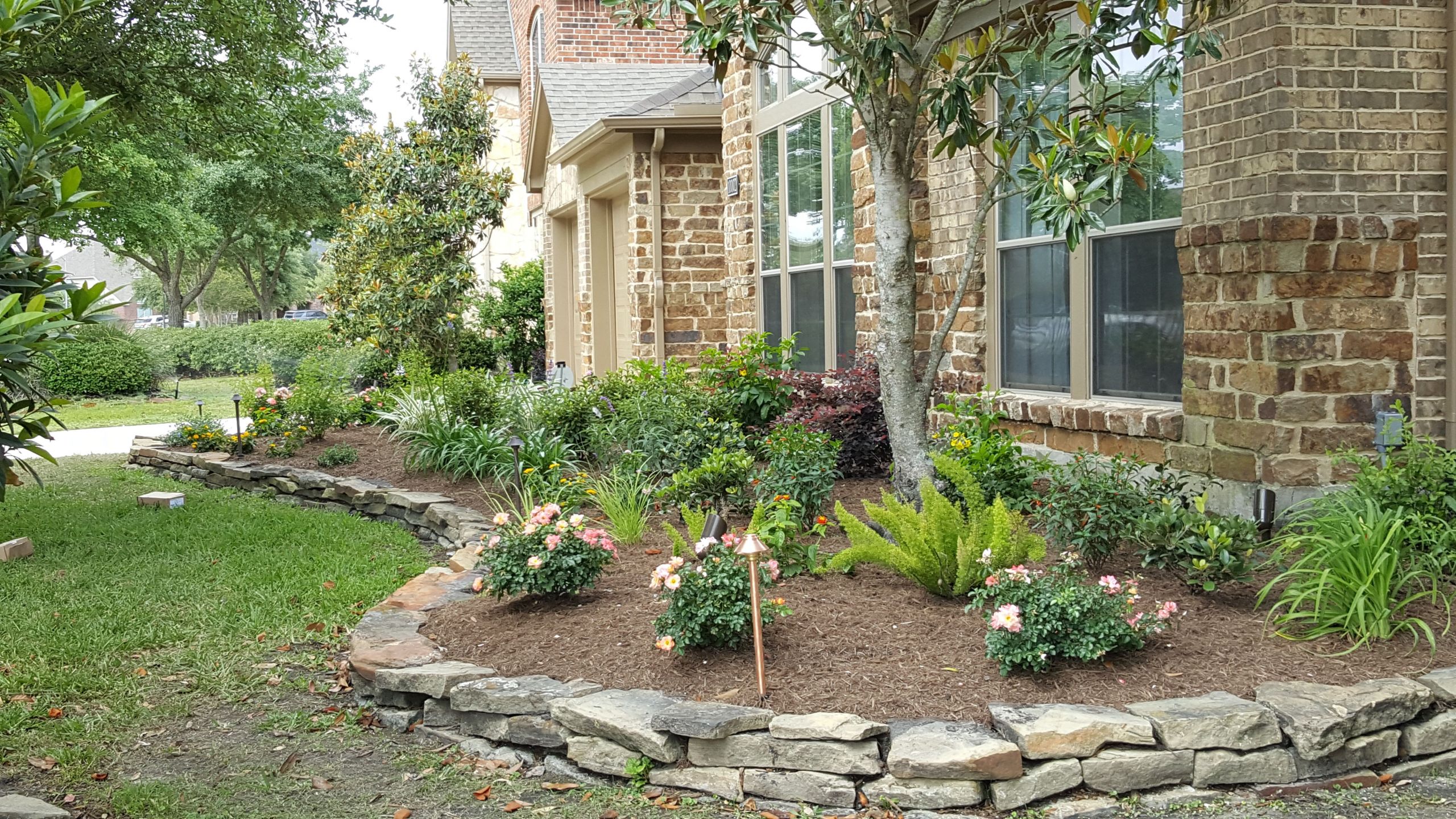 Stacked Stone Landscape Edging
 Classic Houston area raised flowerbed edged with stacked