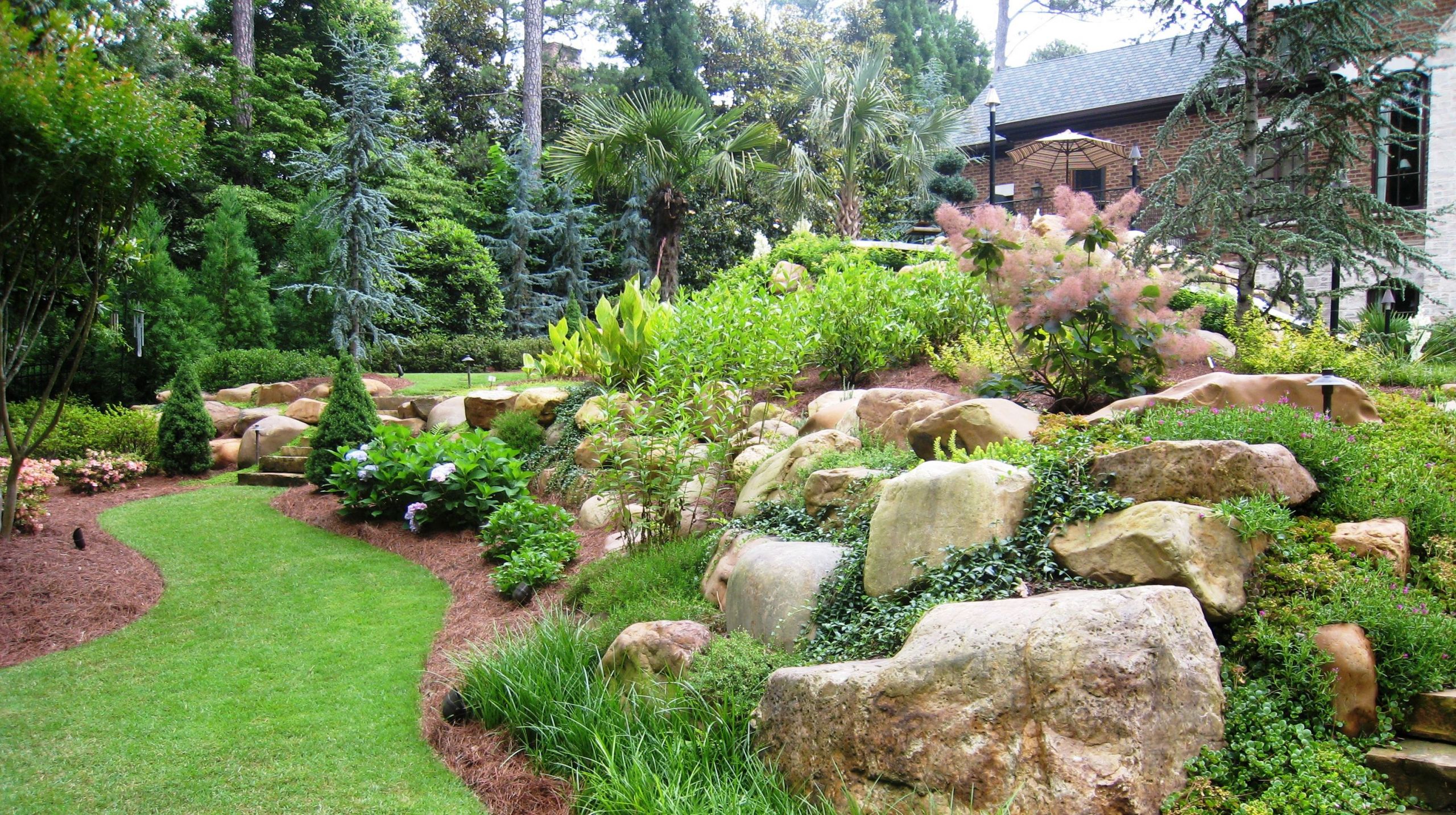 Terrace Landscape With Boulders
 natural boulders bined with shrubs and perennials
