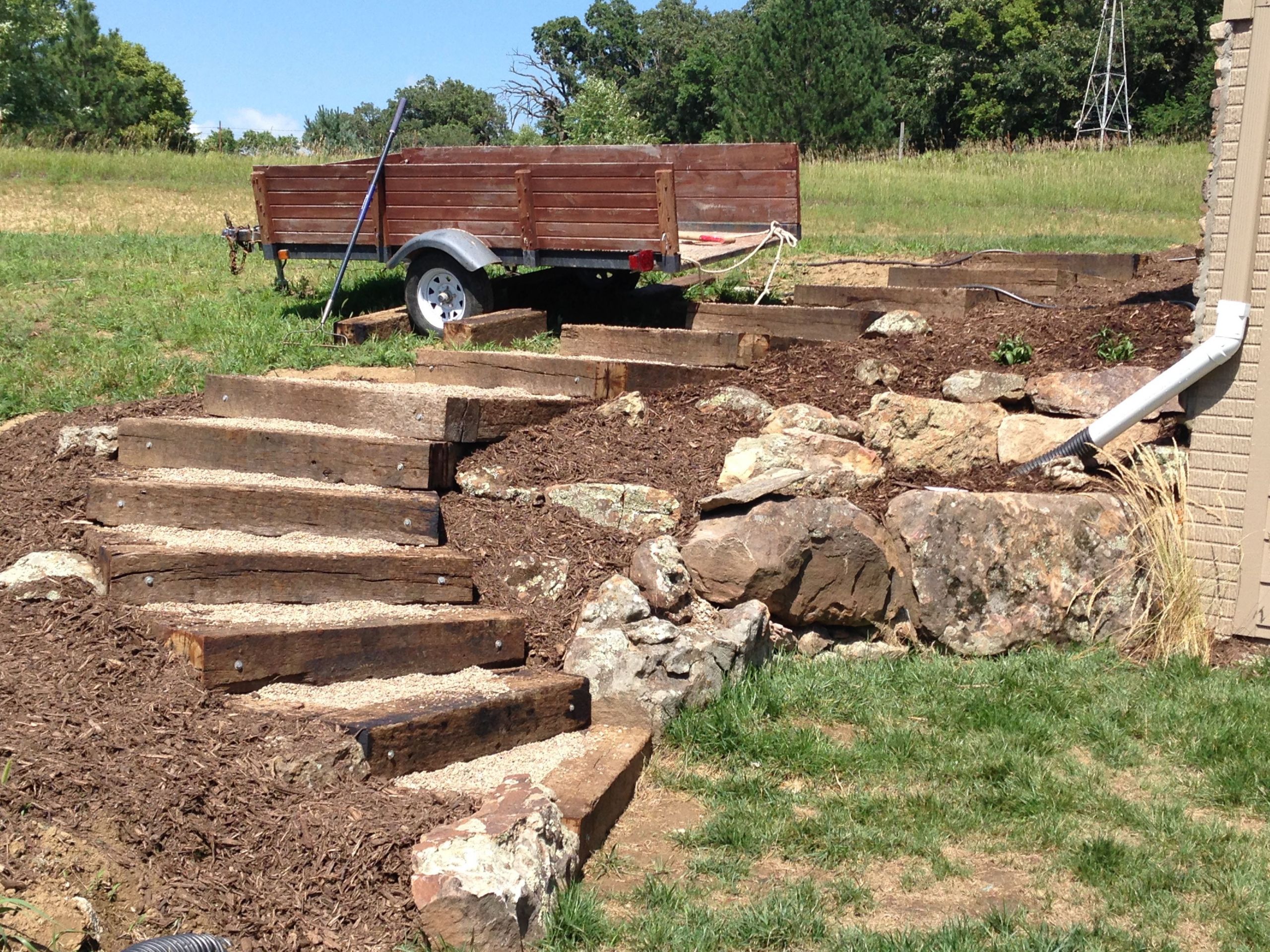 Terrace Landscape With Railroad Ties
 Railroad tie timber steps filled with pea gravel Outdoor
